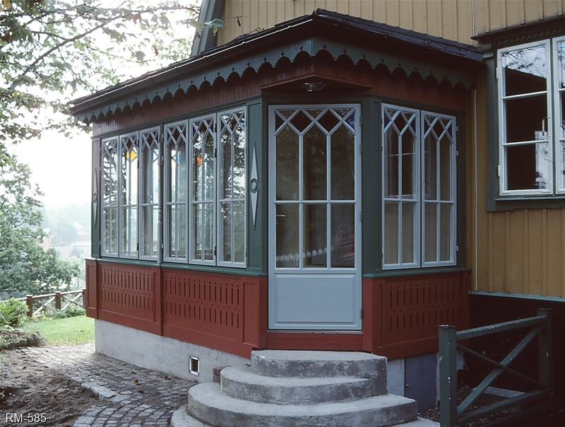 Punchveranda med färgat glas och spröjs.